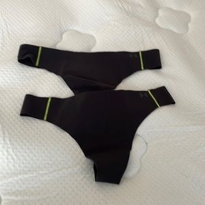 Set of under armor athletic thongs.